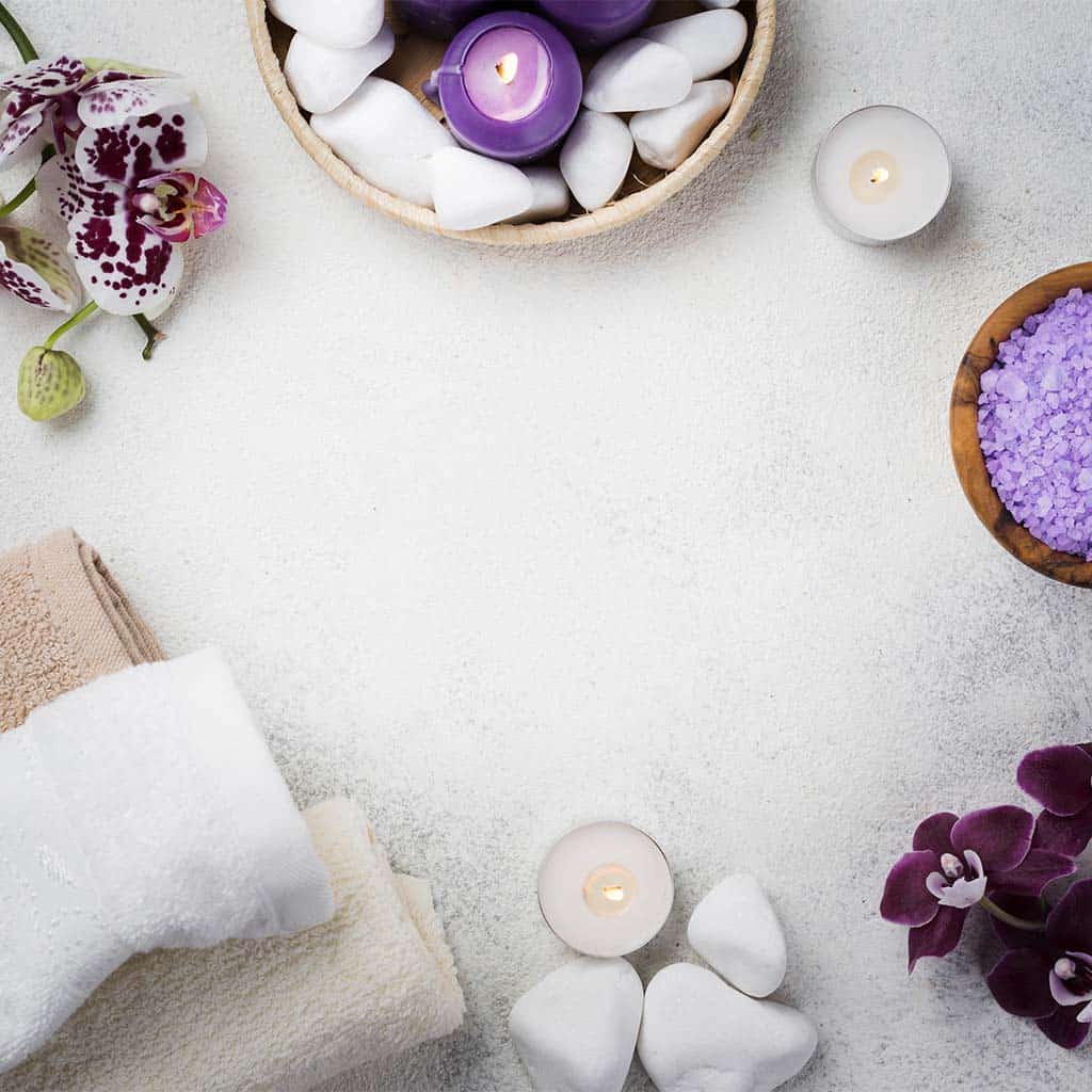 Silk nail polish, manicure tools, and spa accessories arranged on a white textured surface for a relaxing nail care experience at Golden Rose Nail Studio.